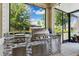 Outdoor kitchen featuring a gas grill, granite countertop and stainless steel storage drawers at 3833 Villamore Ln, Odessa, FL 33556