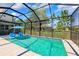 Screened pool with blue water, surrounded by a patio and landscaping at 3833 Villamore Ln, Odessa, FL 33556