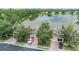 Aerial view of lakefront townhomes showing garages, brick driveways and mature trees at 3918 Silverlake Way, Wesley Chapel, FL 33544