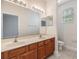 Bathroom features double sinks, a large mirror, and neutral wall color at 3918 Silverlake Way, Wesley Chapel, FL 33544