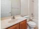 Bright bathroom featuring a vanity with sink, toilet, shower and tub combo, and a large mirror at 3918 Silverlake Way, Wesley Chapel, FL 33544