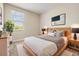 Modern bedroom with window, bright natural light, neutral wall color, and stylish decor at 3918 Silverlake Way, Wesley Chapel, FL 33544