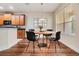 Cozy dining area featuring hardwood floors, modern table, and a window with natural light at 3918 Silverlake Way, Wesley Chapel, FL 33544