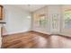 Bright dining area with hardwood floors, large windows, and an access door to the outdoors at 3918 Silverlake Way, Wesley Chapel, FL 33544