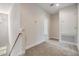 Hallway with carpet, white trim, and views of a window at 3918 Silverlake Way, Wesley Chapel, FL 33544