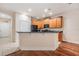 Well-lit kitchen featuring wooden cabinets, dark countertops, stainless steel appliances, and tile flooring at 3918 Silverlake Way, Wesley Chapel, FL 33544