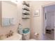 Stylish bathroom with modern fixtures, decorative shelves, and organized storage at 411 Locklie St, Dunedin, FL 34698