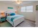 Bright and airy bedroom features coastal decor, a large window, ceiling fan and a comfortable bed at 411 Locklie St, Dunedin, FL 34698