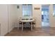 Cozy dining area with white table, two chairs, stylish decor, and plenty of natural light at 411 Locklie St, Dunedin, FL 34698