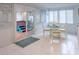 Bright dining area with white tile floors and sliding glass doors at 411 Locklie St, Dunedin, FL 34698