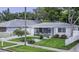 Charming single-story home with well-manicured lawn, picket fence, screened porch and detached garage at 411 Locklie St, Dunedin, FL 34698