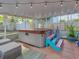 Outdoor hot tub on patio with overhead lighting, seating, and lush foliage at 411 Locklie St, Dunedin, FL 34698