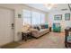 Cozy living room with many windows, wood floors, and comfortable couch at 411 Locklie St, Dunedin, FL 34698