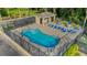 Aerial view of a spacious pool, lounge chairs and tables under umbrellas at 4322 Fincastle Ct, Tampa, FL 33624