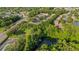 Overhead view of a community boasting lush greenery, a pond, and well-maintained townhome exteriors at 4322 Fincastle Ct, Tampa, FL 33624