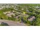 Aerial view of a neighborhood with townhomes, parking, and lush greenery around a picturesque pond at 4322 Fincastle Ct, Tampa, FL 33624