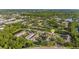 Aerial perspective of a townhome community with a scenic pond, parking, and surrounding greenery at 4322 Fincastle Ct, Tampa, FL 33624