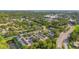 Aerial view of townhomes in a community surrounded by lush trees and a scenic pond at 4322 Fincastle Ct, Tampa, FL 33624