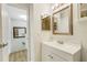 Bright bathroom featuring a vanity with white cabinets and framed mirrors at 4322 Fincastle Ct, Tampa, FL 33624