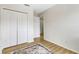 Bedroom featuring light walls, wood floors, a double door closet and a doorway at 4322 Fincastle Ct, Tampa, FL 33624
