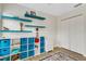 Bedroom with built-in blue shelving and cabinets plus laminate floors at 4322 Fincastle Ct, Tampa, FL 33624