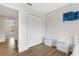 Bedroom featuring light walls, wood floors, and a large closet at 4322 Fincastle Ct, Tampa, FL 33624