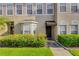 Attractive townhome entrance with a well-manicured lawn, decorative awning, and charming curb appeal at 4322 Fincastle Ct, Tampa, FL 33624