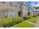 Inviting townhome featuring well-kept landscaping, an awning-covered entrance, and a lovely walkway at 4322 Fincastle Ct, Tampa, FL 33624