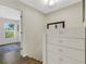 Bright hallway showcasing hardwood floors and a dresser with a mirror at 4322 Fincastle Ct, Tampa, FL 33624