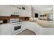 Bright kitchen boasts white cabinets, granite counters, stainless appliances, and a mosaic backsplash at 4322 Fincastle Ct, Tampa, FL 33624