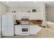 Well-lit kitchen features white cabinets, granite counters, stainless appliances, and a tiled backsplash at 4322 Fincastle Ct, Tampa, FL 33624