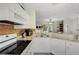 Bright kitchen boasts white cabinets, granite counters, stainless appliances, and a mosaic backsplash at 4322 Fincastle Ct, Tampa, FL 33624