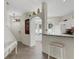 Open kitchen view with a breakfast bar, granite countertops, and white cabinetry at 4322 Fincastle Ct, Tampa, FL 33624