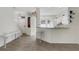 Open kitchen view with a breakfast bar, granite countertops, and white cabinetry at 4322 Fincastle Ct, Tampa, FL 33624