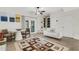 Bright living room featuring a ceiling fan, neutral paint, stylish rug, and comfortable seating area at 4322 Fincastle Ct, Tampa, FL 33624
