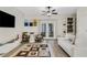 A well-lit living room with a contemporary rug, a ceiling fan, and French doors leading to the outside at 4322 Fincastle Ct, Tampa, FL 33624