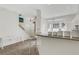 Open-concept living space with bar seating, leading to a bright entryway and stairs at 4322 Fincastle Ct, Tampa, FL 33624