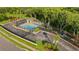 Aerial view of a community pool, playground, and recreational area surrounded by lush greenery at 4322 Fincastle Ct, Tampa, FL 33624