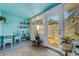 Bright sunroom featuring tiled floors, and a desk area with abundant natural light filtering through multiple windows at 4322 Fincastle Ct, Tampa, FL 33624