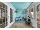 A cozy sunroom with blue walls, a tiled floor, and a desk area with natural lighting at 4322 Fincastle Ct, Tampa, FL 33624