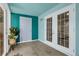 Bright sunroom with tiled floor, vibrant accent wall, multiple windows and doors for natural light at 4322 Fincastle Ct, Tampa, FL 33624