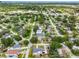 An aerial view showcasing a tranquil neighborhood with tree-lined streets and diverse housing options, promoting community charm at 4401 S Trask St, Tampa, FL 33611