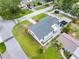 Aerial view showcasing the home, roof, driveway, landscaping, and surrounding neighborhood with tree-lined streets at 4401 S Trask St, Tampa, FL 33611