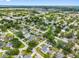 Aerial view of neighborhood, featuring tree-lined streets, residential homes, and glimpses of the water in the distance at 4401 S Trask St, Tampa, FL 33611