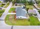Aerial view showcasing the home's manicured lawn, landscaping, roof, and surrounding residential neighborhood at 4401 S Trask St, Tampa, FL 33611