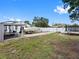 Backyard area showcasing a boat under a covered area, a trampoline, and a fenced yard, perfect for outdoor activities at 4401 S Trask St, Tampa, FL 33611
