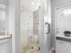 Bathroom featuring tiled shower with glass door and adjacent vanity with sink at 4401 S Trask St, Tampa, FL 33611