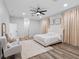 Bright primary bedroom featuring neutral colors, plank flooring, decorative window coverings and modern ceiling fan at 4401 S Trask St, Tampa, FL 33611