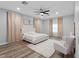 Bright primary bedroom featuring neutral colors, plank flooring, decorative window coverings and new ceiling fan at 4401 S Trask St, Tampa, FL 33611