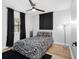 Bedroom featuring a bed with modern print, black curtains and a ceiling fan at 4401 S Trask St, Tampa, FL 33611